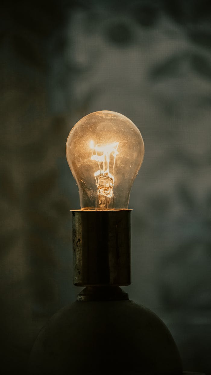 why-choose-us-02 A close-up of a glowing light bulb with a warm ambiance against a blurred background.